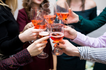 company hands with glasses check out to celebrate a toast