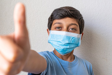 great boy with blue shirt preventing corona virus