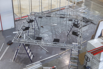Installation of a suspended lighting structure before the exhibition.