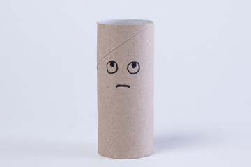 empty toilet paper roll with angry and sad face because the paper is gone