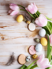 Fototapeta na wymiar Beautiful Easter composition of eggs with natural colors, gingerbread, flowers, feathers.
