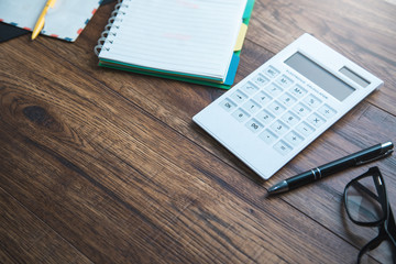 calculator and letters on desk