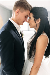 Groom and bride are gentle and in love.
