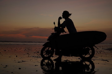 Fototapeta na wymiar silhouette of man on bike in desert