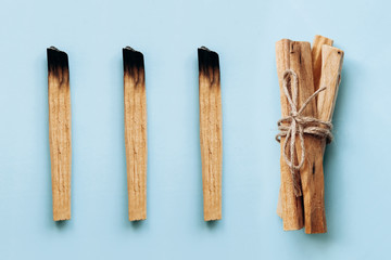 Palo Santo sticks on a blue background. They are used in aromatherapy and religious rites and meditations.