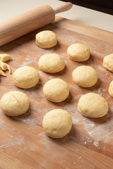 Homemade doughnuts made from yeast dough and filled with marmalade rising before being fried