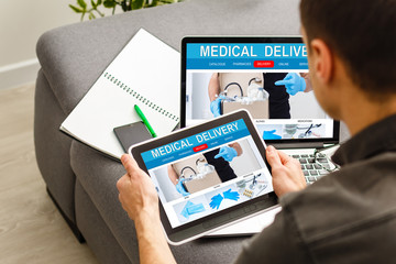 Pharmacist using the computer laptop in chemist shop or pharmacy drug store.