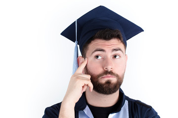New graduate student with graduation robe thoughtful and question mark on his head. white background