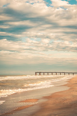 Sky, Waves, Sand, and Pier in Late Afternoon Light