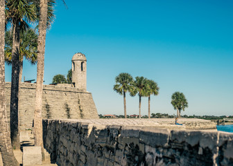 Fototapeta na wymiar Fort in Florida with Sea Wall and Palm Trees Along the Shore