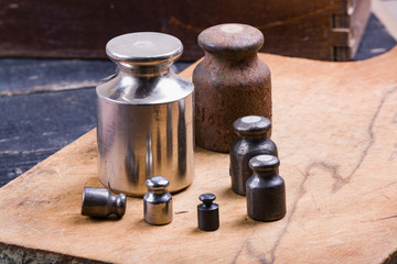 vintage iron weights for weighing goods on a wooden background