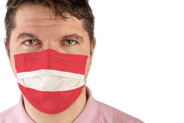 Portrait of adult caucasian man who wears protective mask on his face against influenza and protect health from bacteria. Flag of Austria.