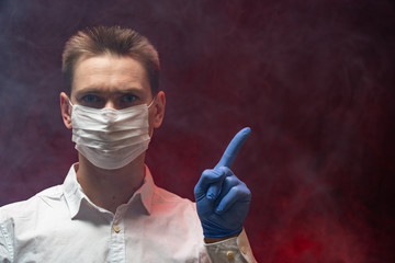 The doctor shows that it is necessary to use a respiratory mask in an epidemic. copy space