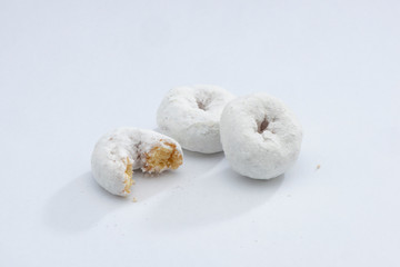White Powdered Sugar Donuts on a White Background