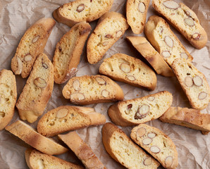 pieces of baked italian christmas biscotti cookies on a brown crumpled paper
