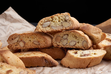 pieces of baked italian christmas biscotti cookies on a brown crumpled paper