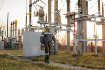The energy engineer inspects the equipment of the substation. Power engineering. Industry