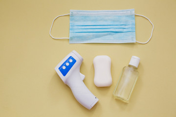 protection during virus outbreak concept: surgical mask, soap, hand sanitizer and infrared...