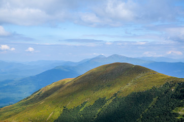 Picturesque mountain slopes, green valleys, beautiful landscape of the Svydovets ridge against a cloudy sky. Ukraine - Powered by Adobe