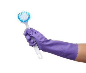 hand in purple rubber glove holds plastic brush for cleaning the house