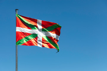 Close up shot of Basque Country waving flag on clear sky background