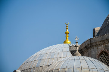Fototapeta na wymiar Detail of a mosque dome with a golden moon on the top in Istanbul Turkey 