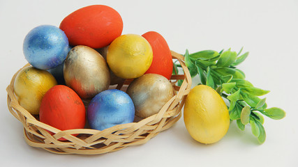 easter eggs in basket on white background