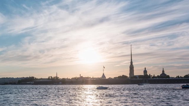 Beautiful timelapse of Peter and Paul fortress in white nights time, boats and ferries pass along the Neva river, St. Petersburg, Russia