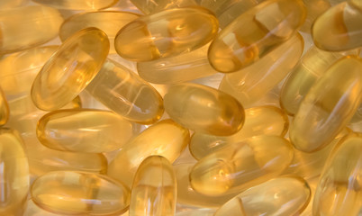 Omega capsules with fish oil with beige background.