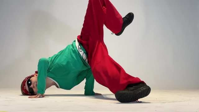 A little boy dancing breakdance, an exceptional child dancing a hard dance.