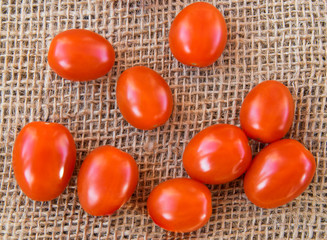 Many red  little tomatoes on the natural background.