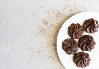 Flat lay, brownie chocolate chip cookies on a white plate