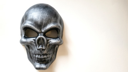 Isolated photo of a black human skull mask on white background front view.