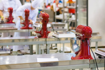 Professional chef, baker workplace with modern kitchen stand food mixers on tables at cuisine of restaurant, bakery. Cooking, catering, culinary, gastronomy and food concept