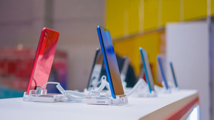 New models of smartphone for sale in electronic shop, store. Prototype, consumerism, entertainment and new technology concept