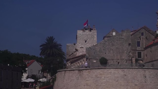 Croatian flag on fortress. Korcula, a Croatian island in the Adriatic Sea. Day trip tour from Split, Croatia. Vacation summer destination in Europe.
