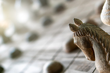 Obraz premium Background of wooden Thai chess game horse, king, queen, pawn on game board for strategy concept. Business strategic to thinking planning to lead during risk virus crisis management economic downturn