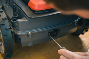Changing the filter or neoprene breather inset for the robotic lawnmower. Changing watertight breather seal for the modern autonomous lawnmower.
