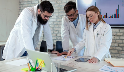 Doctors and medical researchers on conference meeting, discussing possible solutions for resolving a world health crisis. Health and medical care concept. Selective focus.