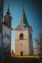 Fototapeta premium Bell tower of Zasavska sveta gora, on a sunny winter day. Beautiful religious chuch on the top of the hill in the centre of Slovenia, above Litija