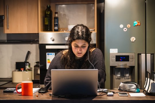 Young spanish girl teleworking at home because of the restrictions given by spanish government due to coronavirus COVID-19 sanitary crysis