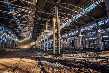 Abandoned large industrial hall with garbage waiting for demolition. Former Voronezh excavator manufacturing factory