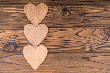 Three hearts, on a wooden background. romantic message, valentine's day. Copy space, lovers day