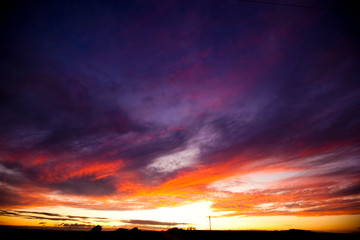 Purple, Pink and Orange Sunset over a Field