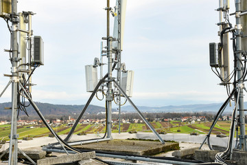 5G new radio telecommunication network antenna mounted on a metal pole providing strong signal...