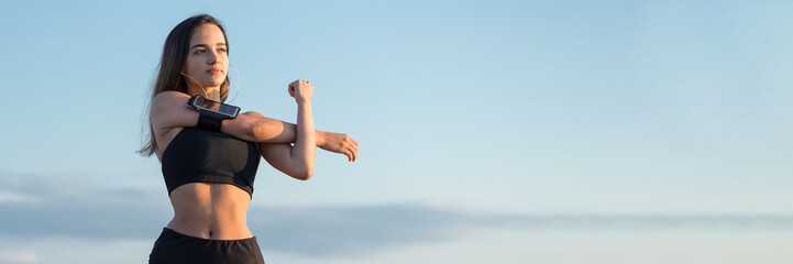 A young slim athletic girl in sportswear with snakeskin prints performs a set of exercises. Fitness and healthy lifestyle.