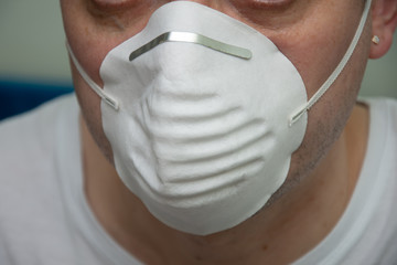 white disposable face mask on a man's face ,Coronavirus mask  (COVID-19)