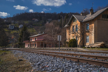 Fototapeta na wymiar Old empty train station of Semic in Slovenia, no trains or passengers are visible on a sunny day in spring.
