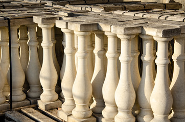 White stone balusters at a construction warehouse.