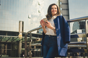 Office buildings city people in suit. Caucasian businesswoman using smartphone with hand. Business...